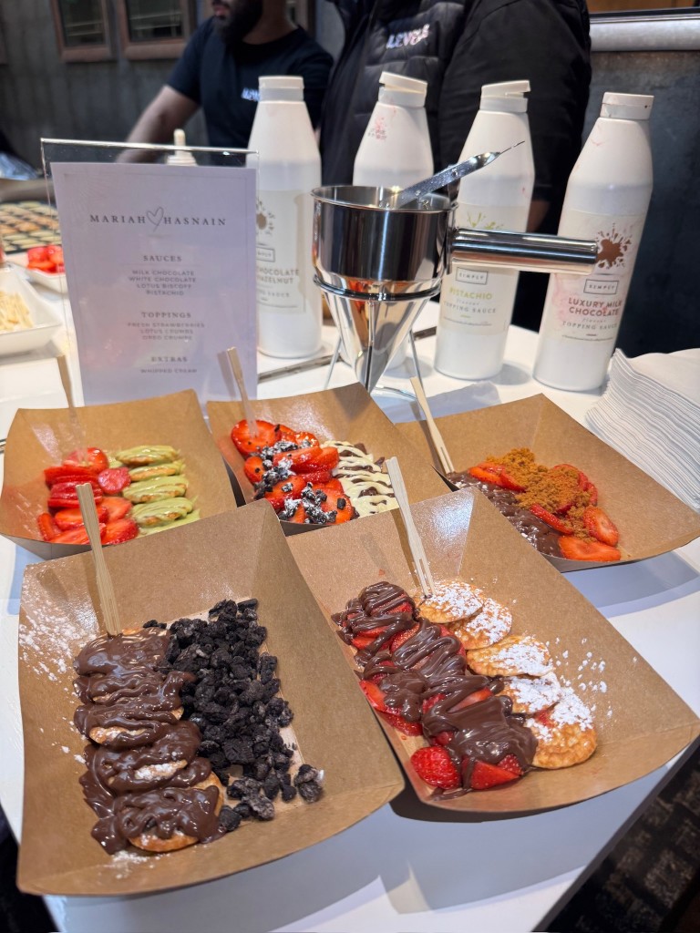 Five mini pancake dessert boats with sauces and toppings